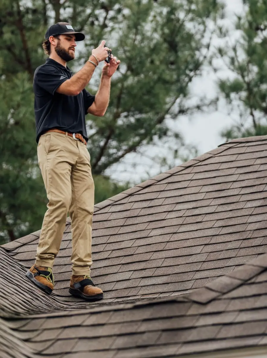 Sideways man working roof with drill